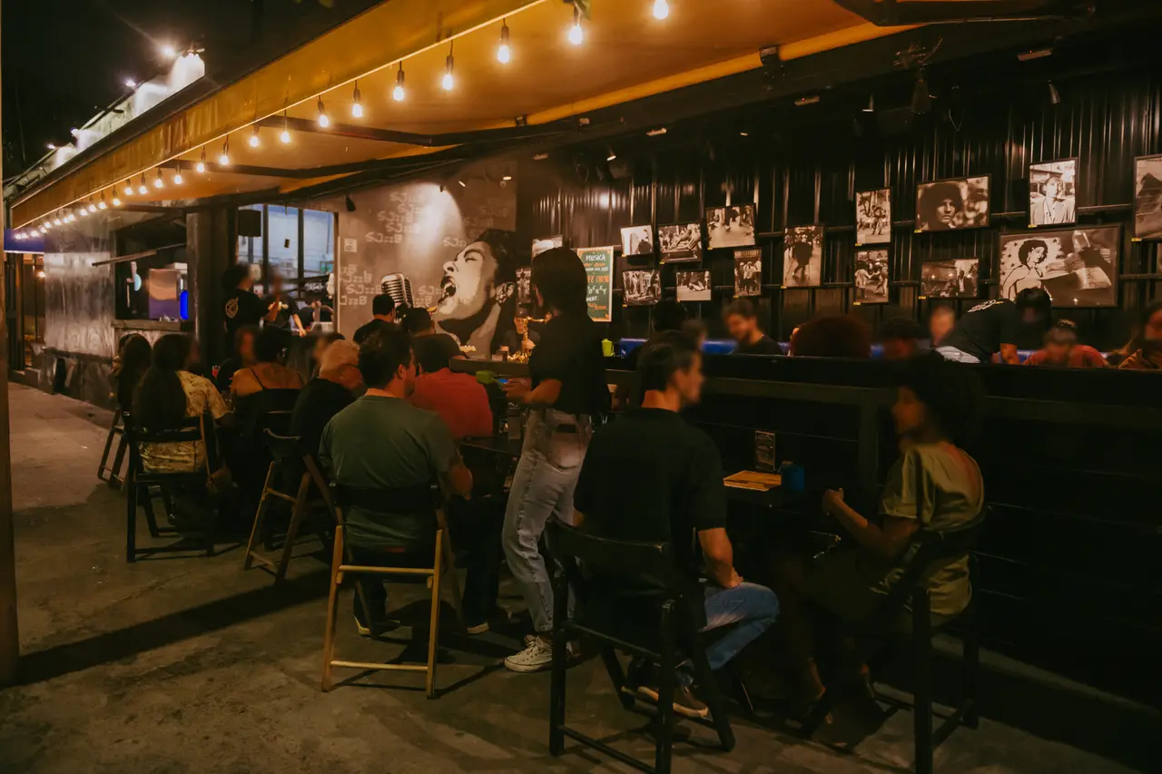 Pampulha cheia à noite, com varal de luzes e o mural ao fundo